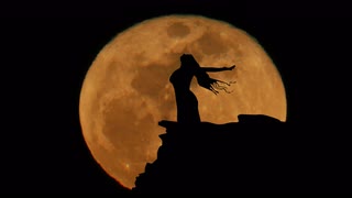 red-moon-rising-women-with-arms-open-wide-silhouette-animation-4k_eolpnlc73l__S0000